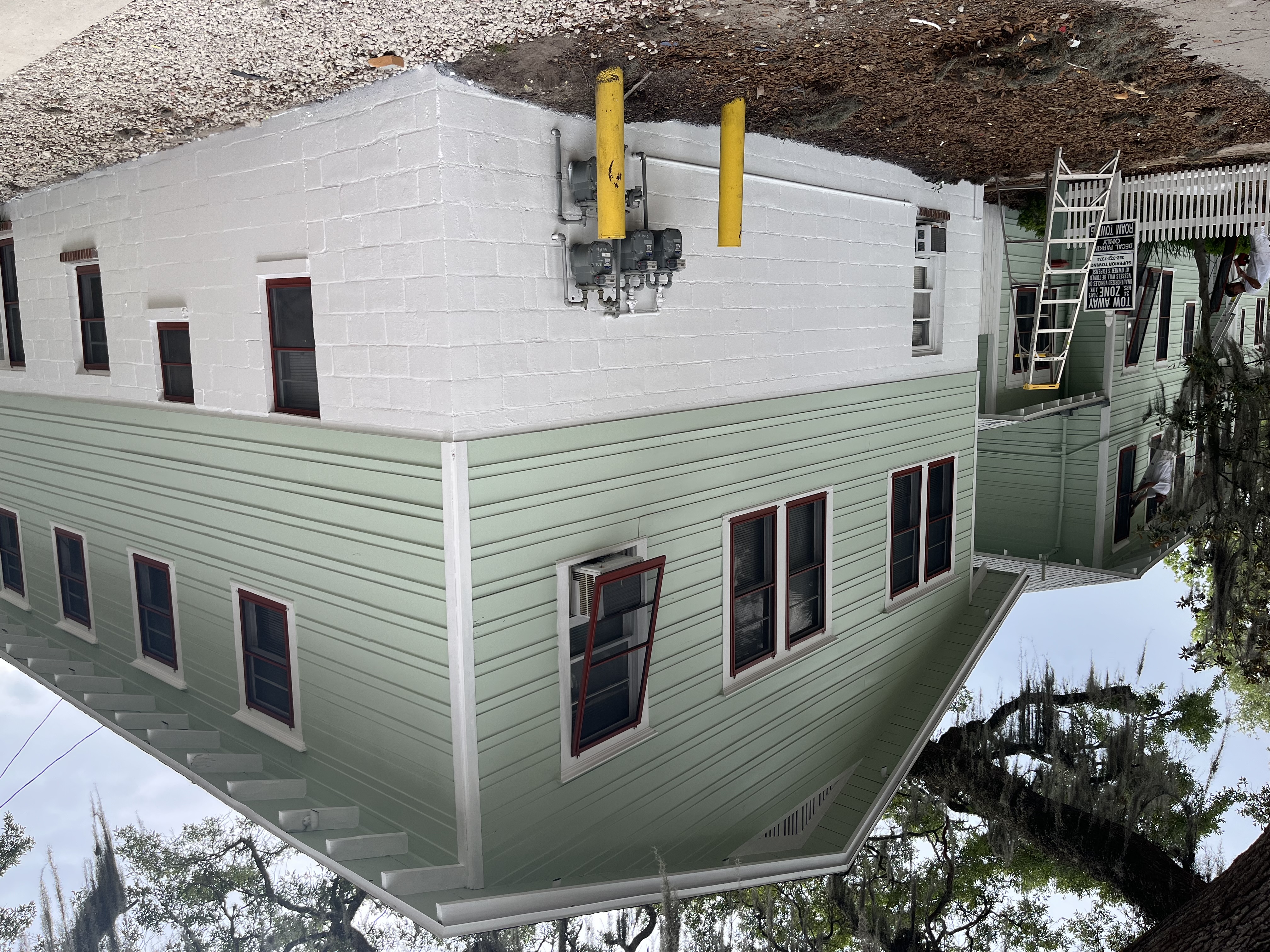 Commercial building exterior painting sage green by HPC in St. Augustine Florida
