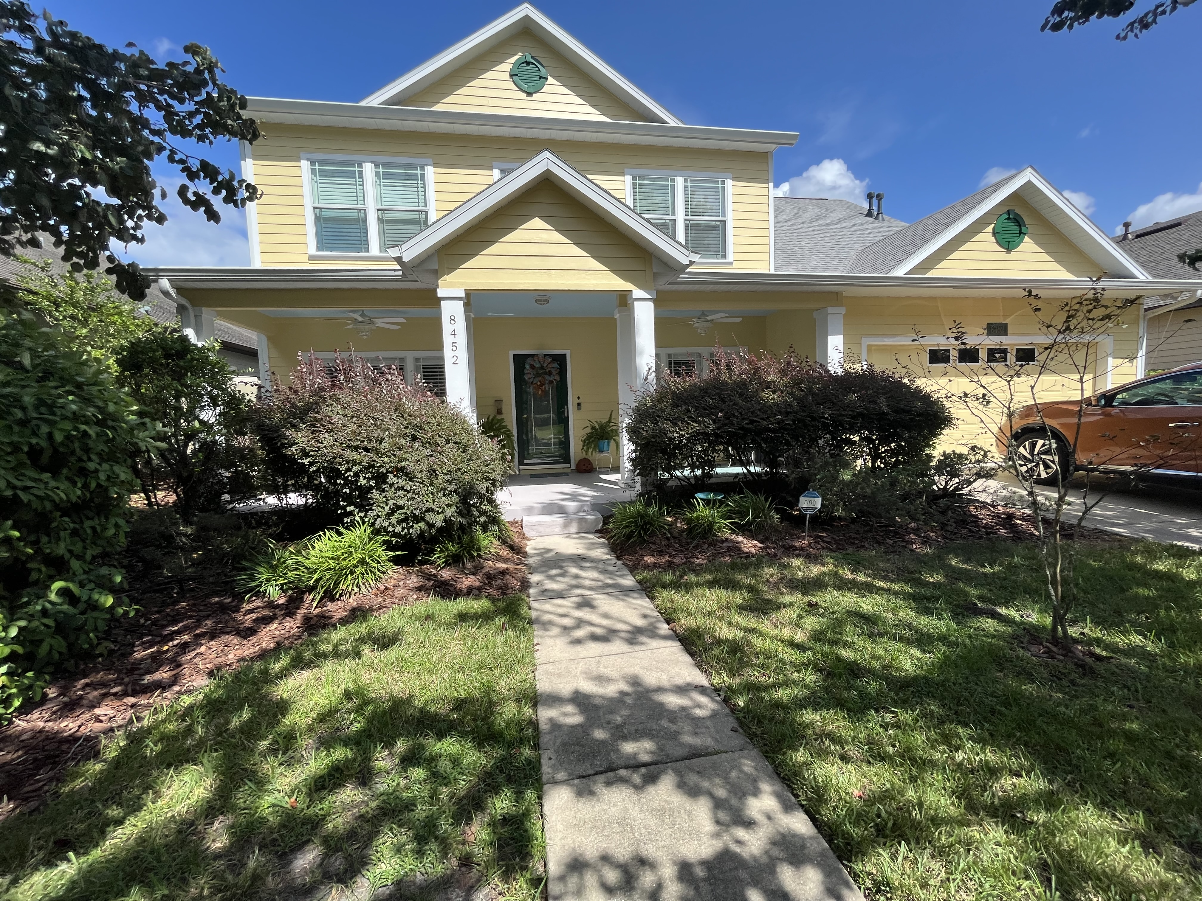 Neighborhood home exterior painting yellow siding white trim by HPC in Jacksonville Florida