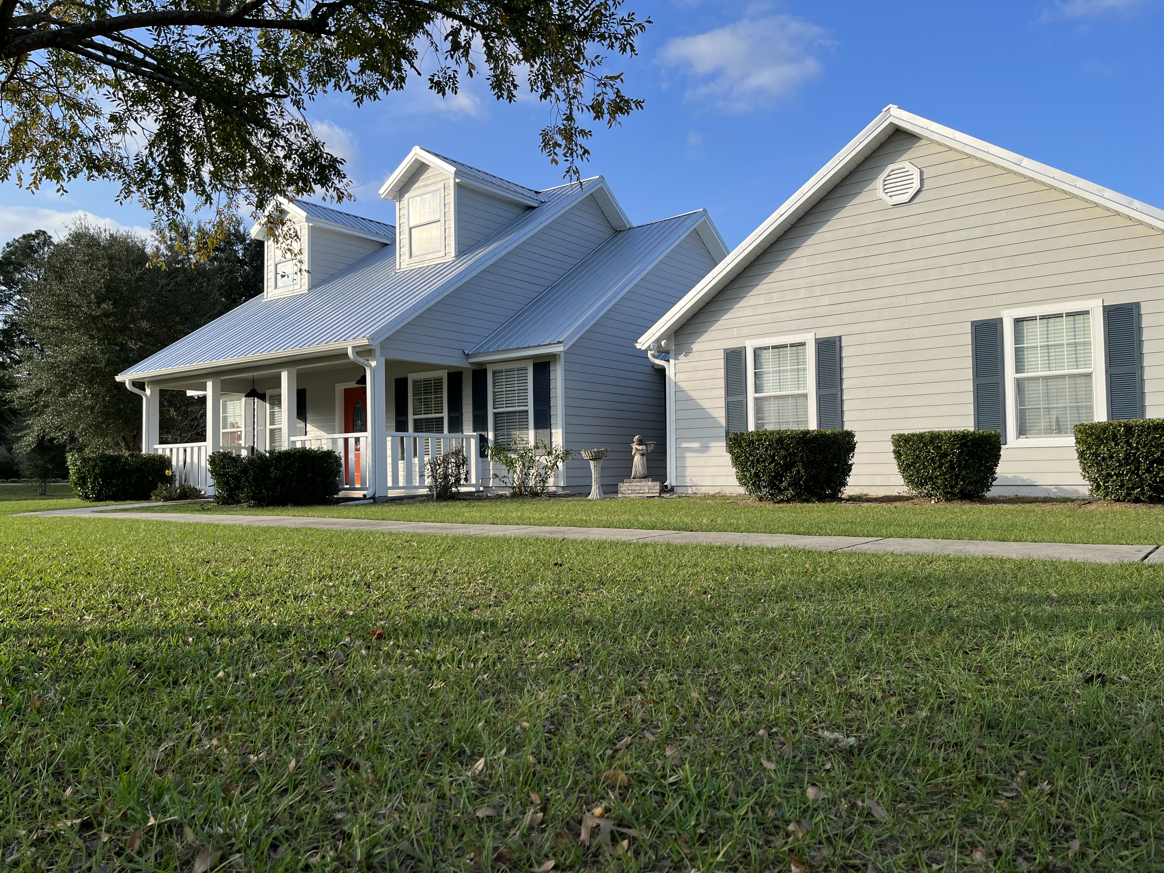 Country home exterior painting gray siding white trim by HPC in Gainesville Florida
