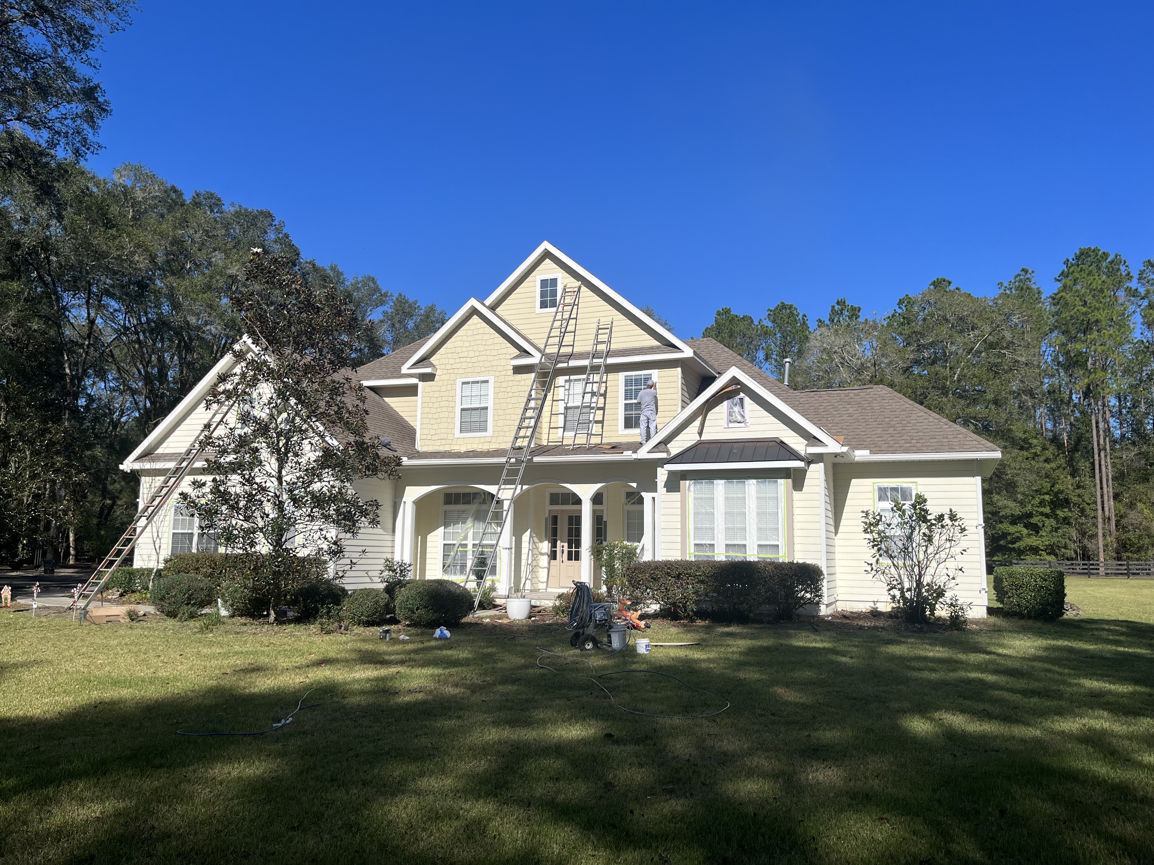 Two story home exterior painting in progress by HPC crew Florida