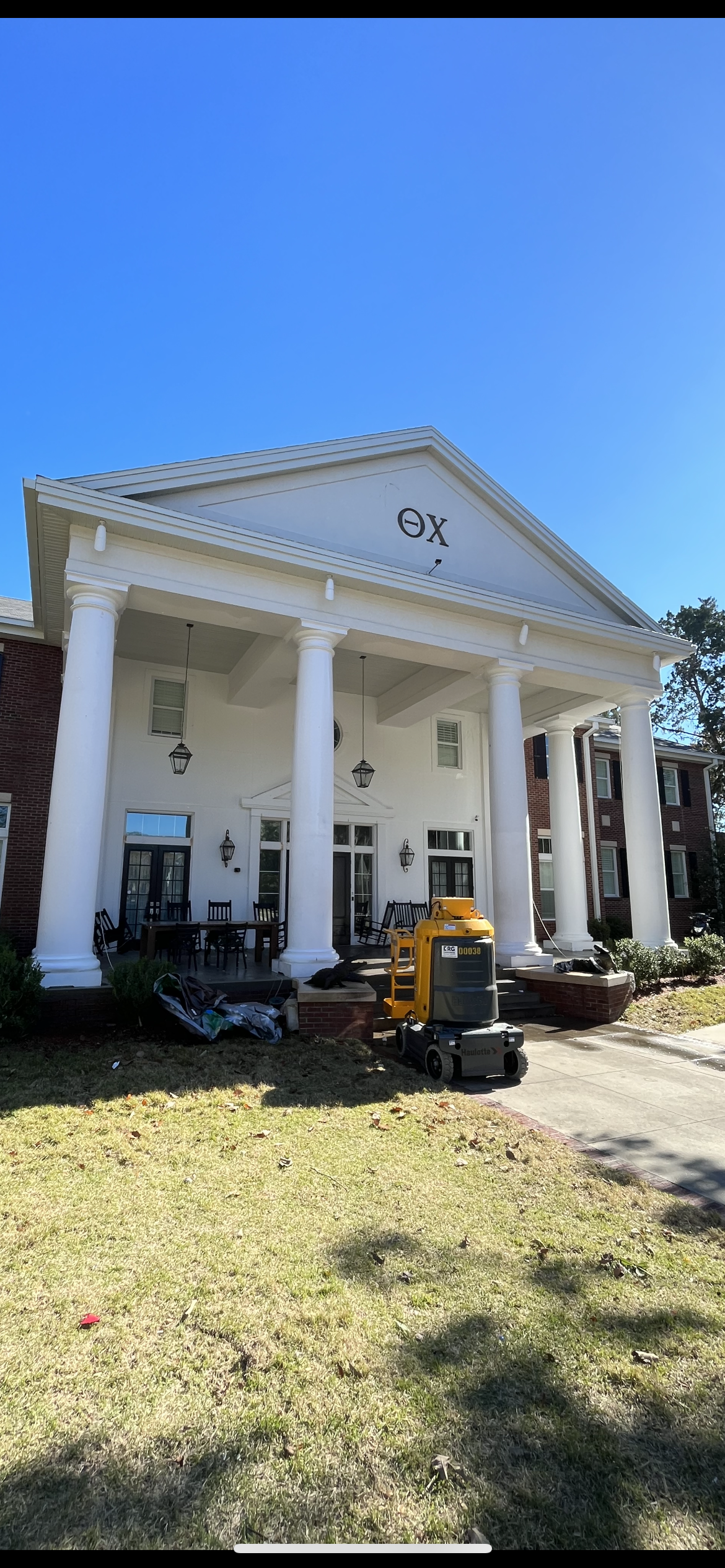 Theta Chi fraternity house exterior painting white columns by HPC in Gainesville Florida