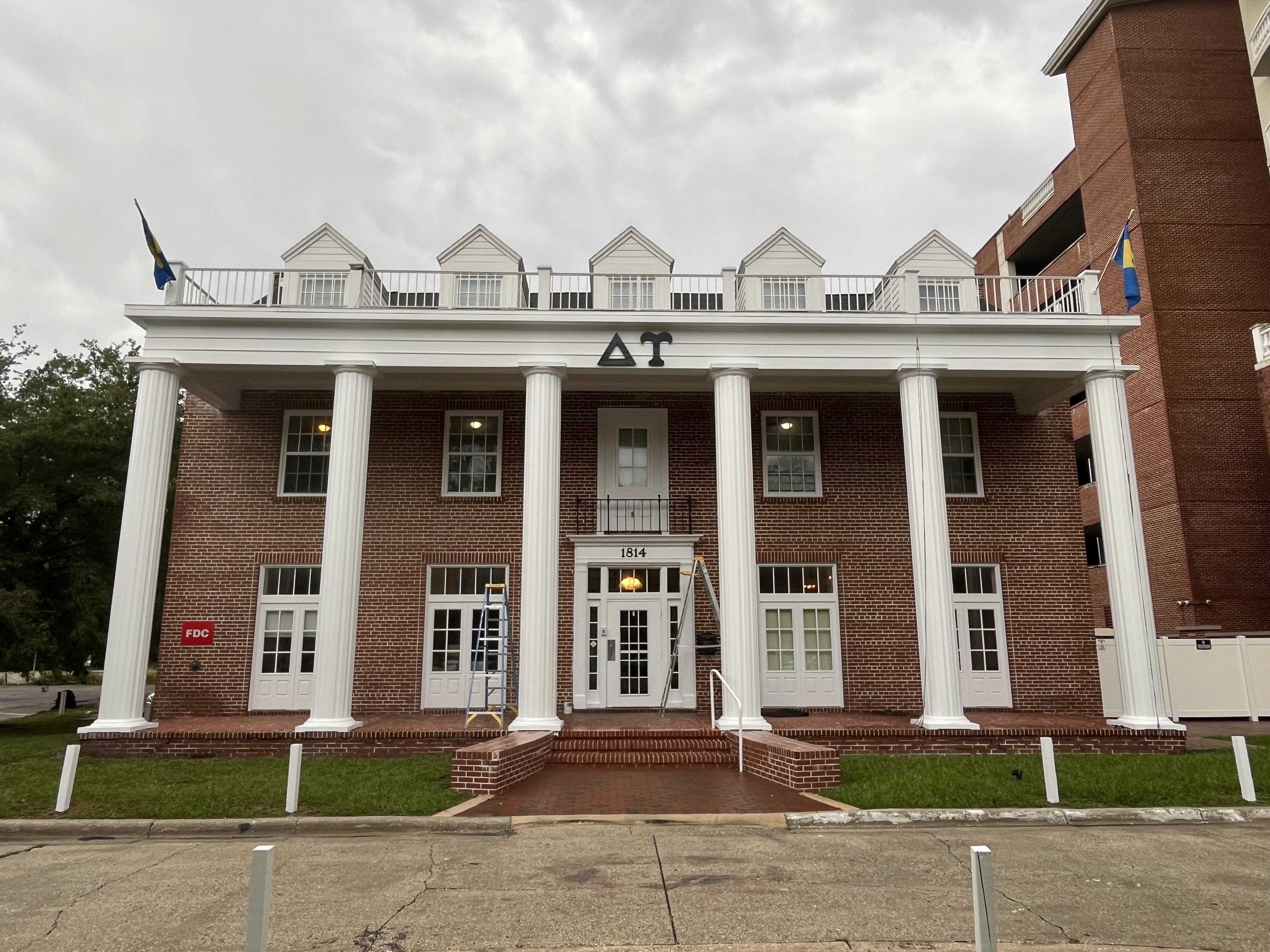 Delta Tau fraternity house exterior painting white columns by HPC in Gainesville Florida