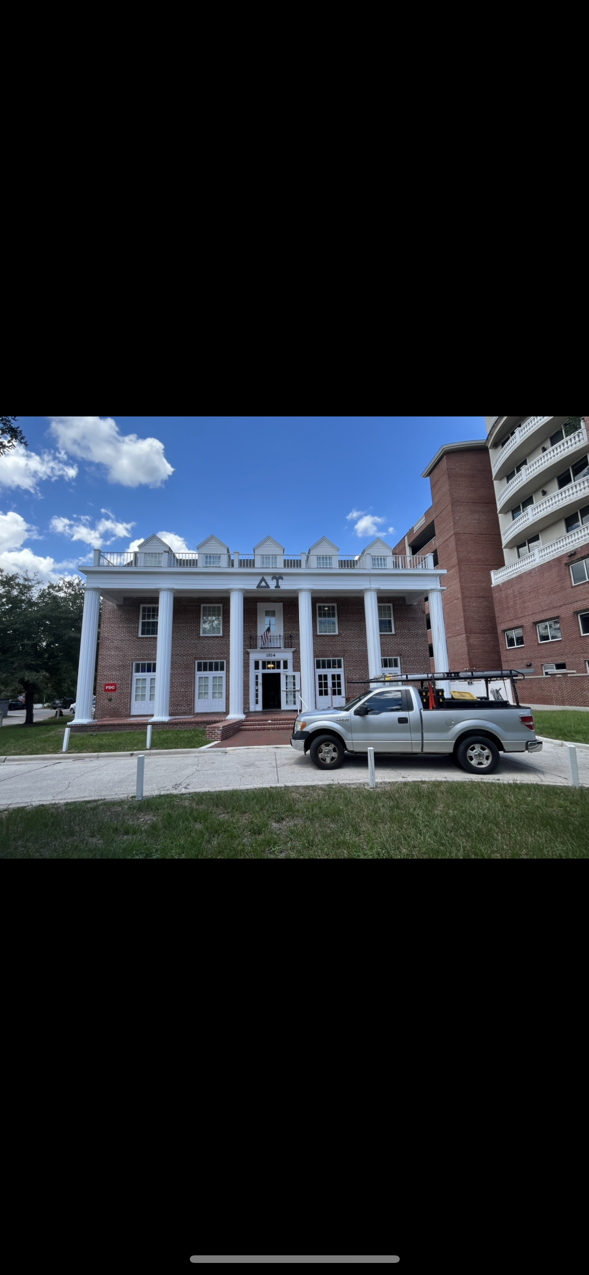 Delta Tau fraternity house exterior painting completed white trim by HPC in Gainesville Florida