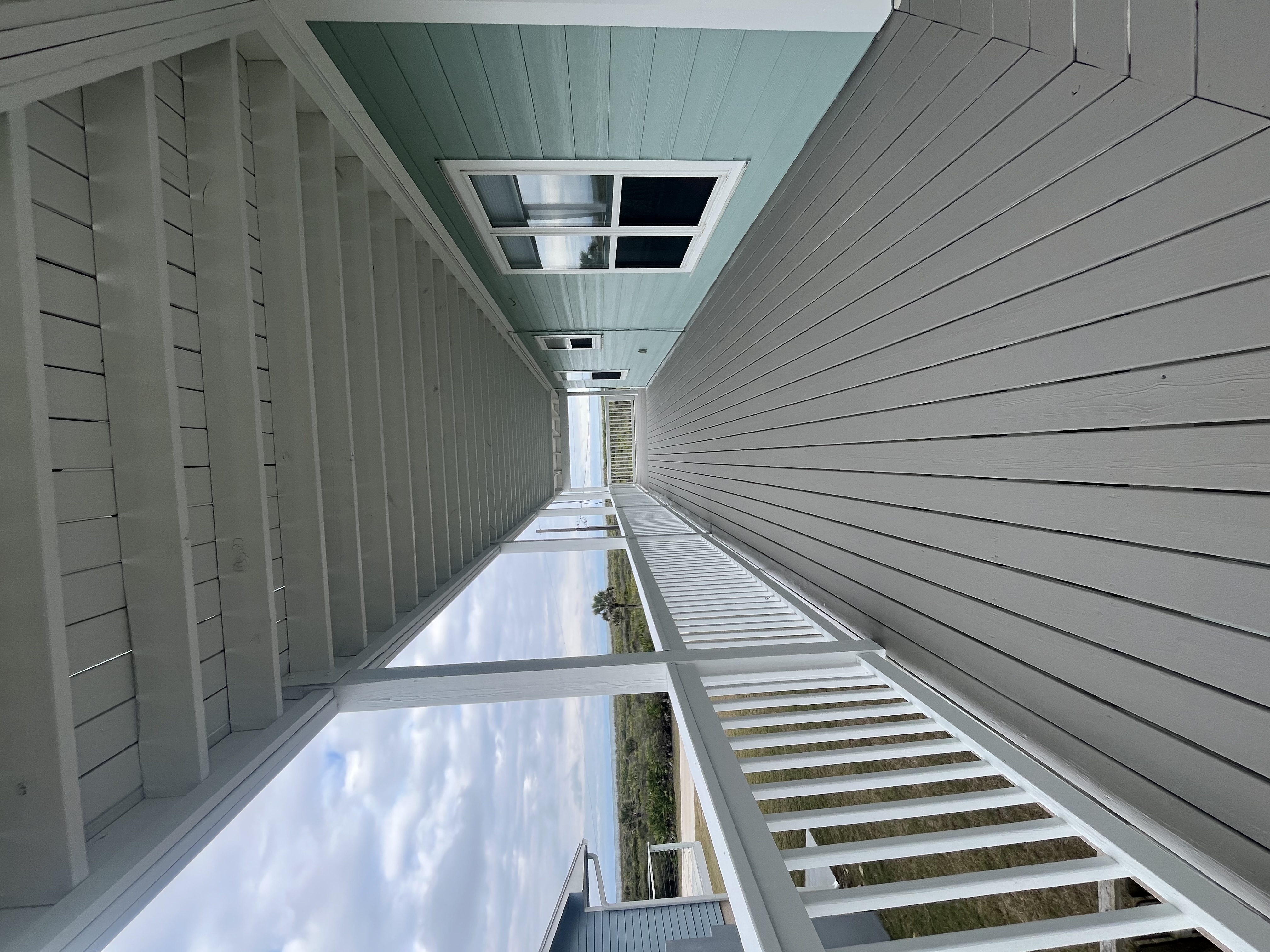 Three story beach house exterior painting aqua white by HPC in St. Augustine Florida