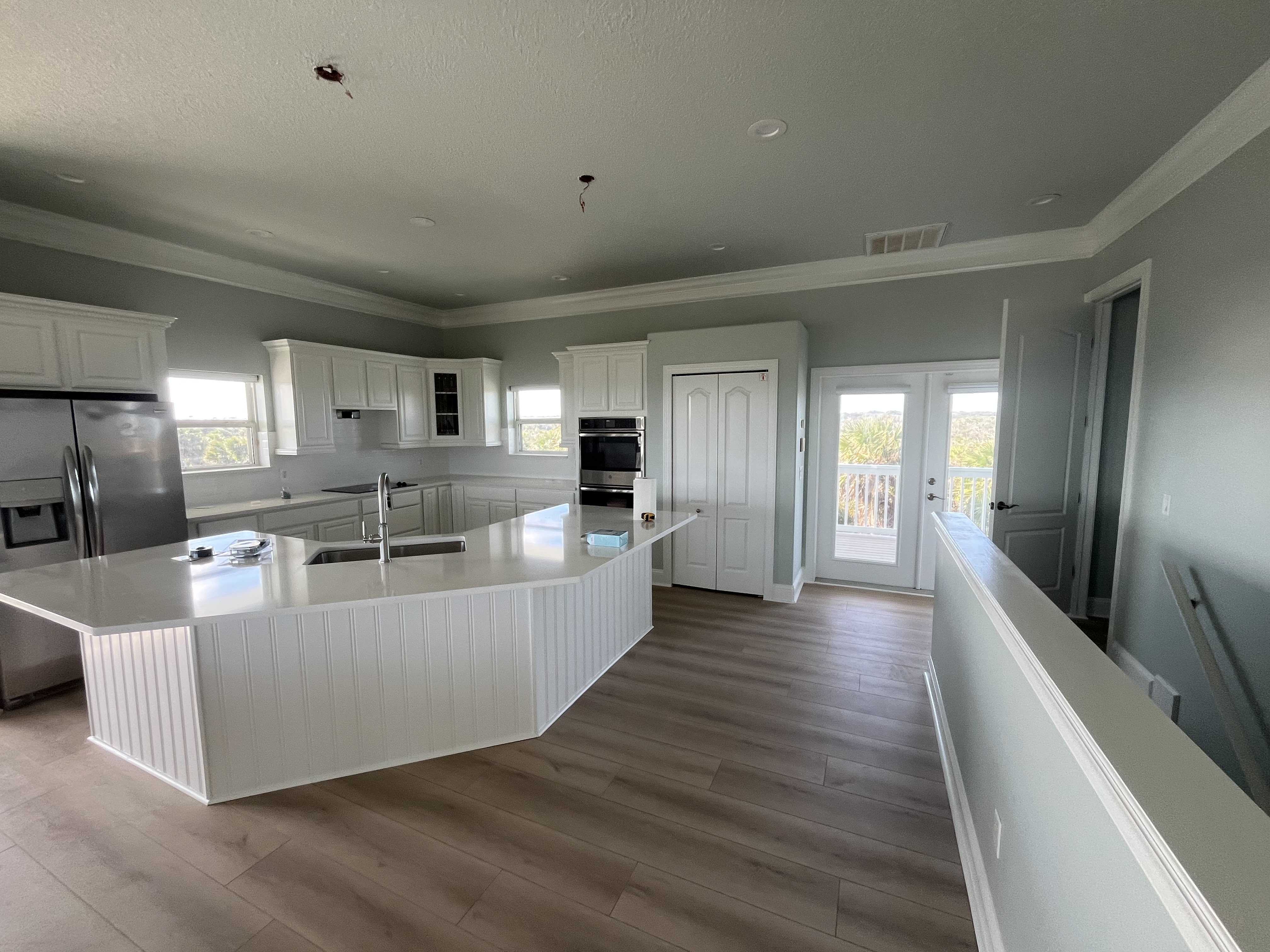 Beach house master bedroom interior painting sage green tray ceiling by HPC in St. Augustine Florida