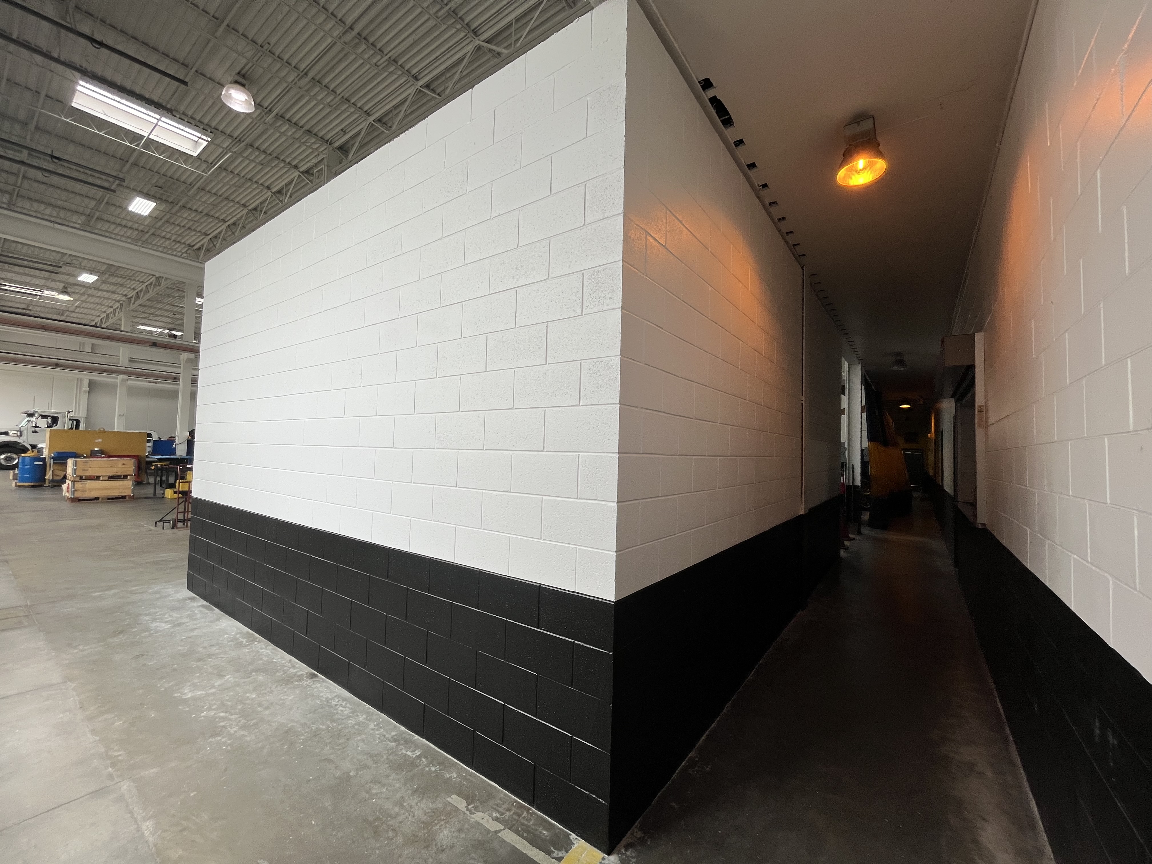 Warehouse interior painting white black block walls by HPC Florida