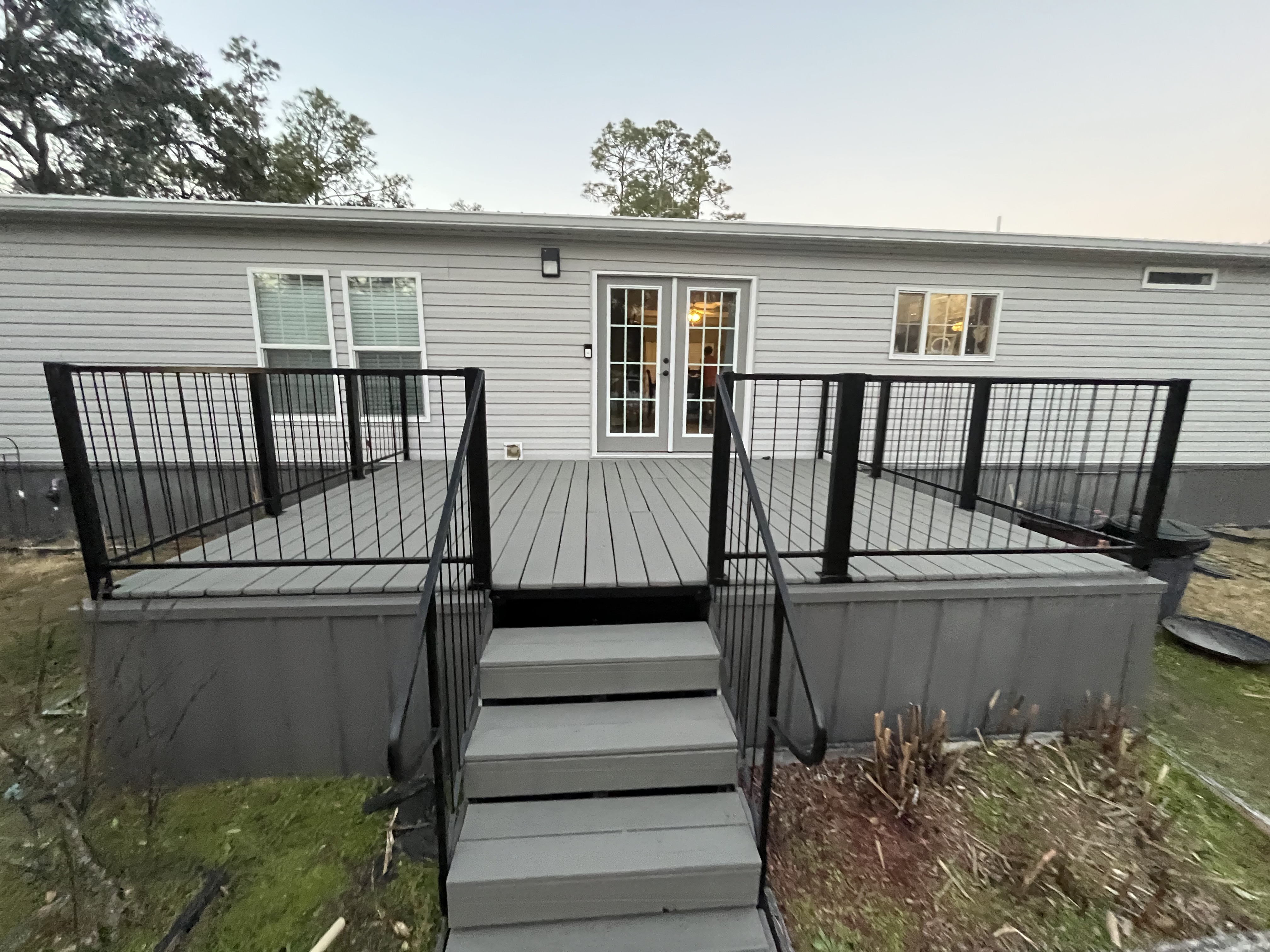 Deck staining gray with black railings exterior painting by HPC in Ocala Florida